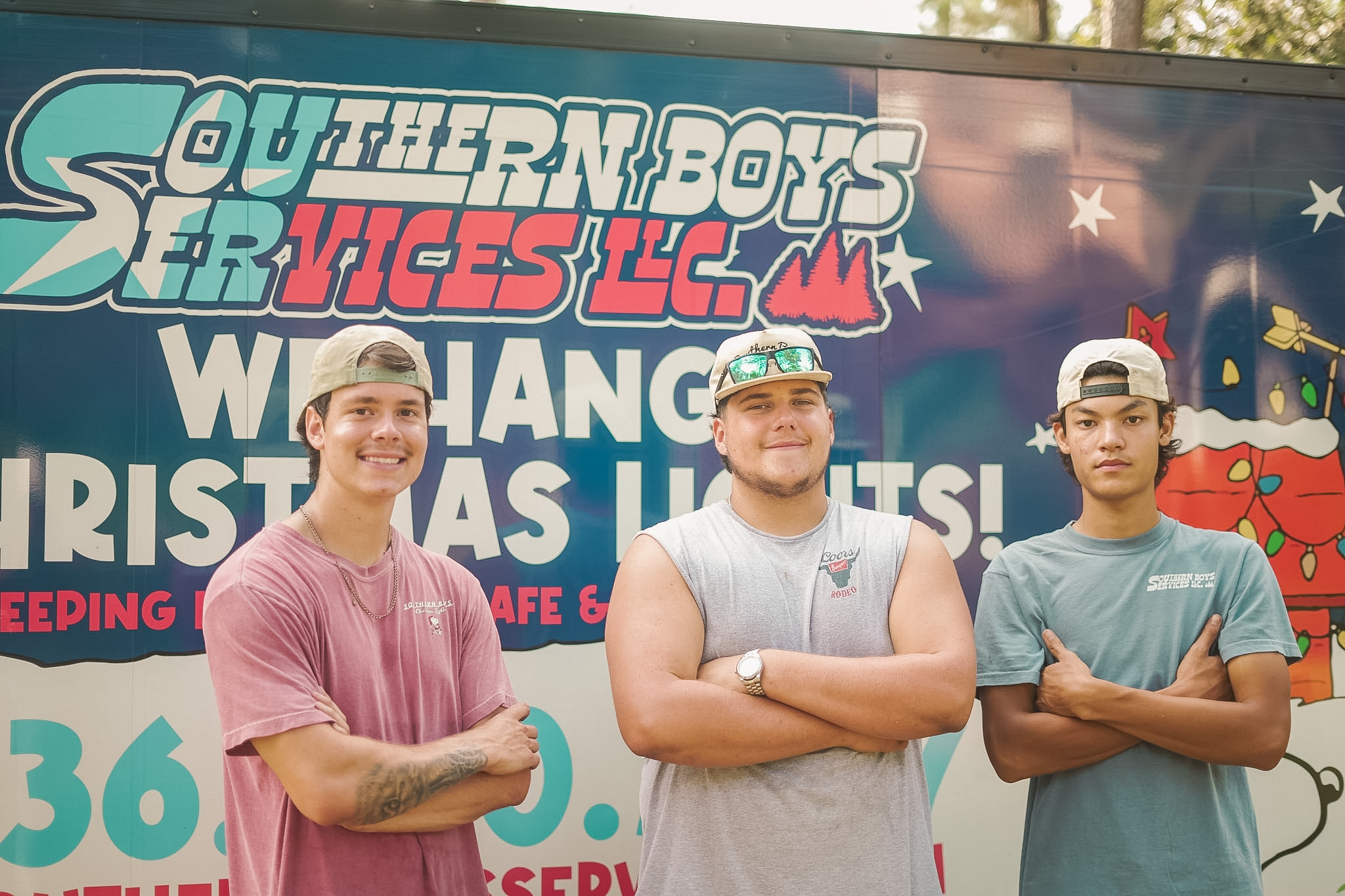 Three Southern Boys crew members in front of their Christmas lights trailer
